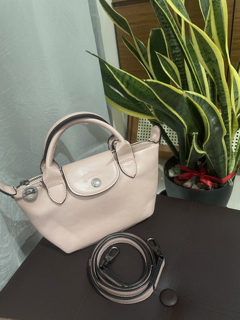 Longchamp Le Pliage Cuir Top Handle Bag (Category: Luxury Bags & Wallets) located in Manila. Submitted by misyeli (Listing ID 1451588446, Image 1). Description: - Authentic Longchamp handbag - Chic light pink color - Genuine leather material - Features a top handle and a detachable shoulder strap - Secure zipper closure - Compact, small size, ideal for everyday essentials.