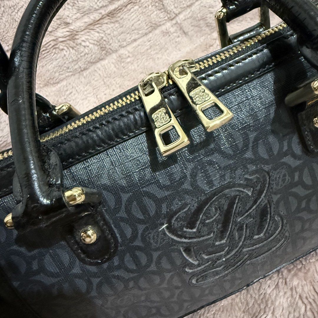 LQ Black Monogrammed Boston Bag with Gold Hardware (Category: Luxury Bags & Wallets) located in Bulacan. Submitted by trendsettersquad (Listing ID 1451687393, Image 3). Description: 🏷️ Item Code: BW02 👜 Brand: Louis Quatorze 📏 Dimensions: 9 × 6 × 4 in. ✨ Condition: Authentic. Good overall condition with patent leather blistering (still intact and barely visible) on the trim due to age and seldom use. Priced accordingly. .