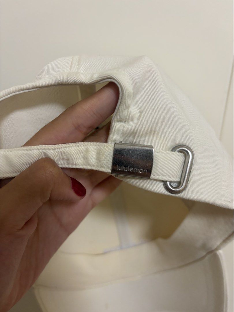 Lululemon Baseball Cap - Cream/Off-White (Category: Caps & Hats) located in Pasig City. Submitted by kevinl12345 (Listing ID 1449139072, Image 3). Description: - Cream Lululemon baseball cap - Size L/XL - Adjustable strap with metal hardware - Embroidered Lululemon logo on front and strap buckle - Made in Vancouver.