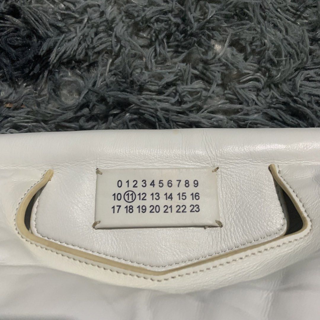 Maison Margiela Glam Slam Bag White Leather (Category: Luxury Bags & Wallets) located in Davao. Submitted by anyastark (Listing ID 1451644962, Image 3). Description: - White Maison Margiela Glam Slam bag - Made from soft, padded leather - Features the iconic number tag - Adjustable shoulder strap for comfort - Ideal as a stylish everyday bag - Issue See Picture.