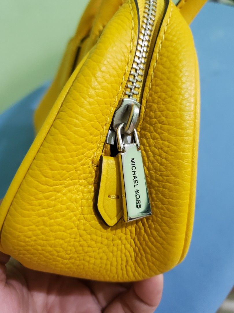 Michael Kors Yellow Leather Satchel Handbag (Category: Luxury Bags & Wallets) located in Navotas City. Submitted by miloklo (Listing ID 1451600010, Image 3). Description: - Bright yellow Michael Kors handbag - Textured pebble leather finish - Iconic MK logo charm - Secure zipper closure - Protective metal feet on the bottom - Ideal size for everyday essentials - Clean and well-maintained .