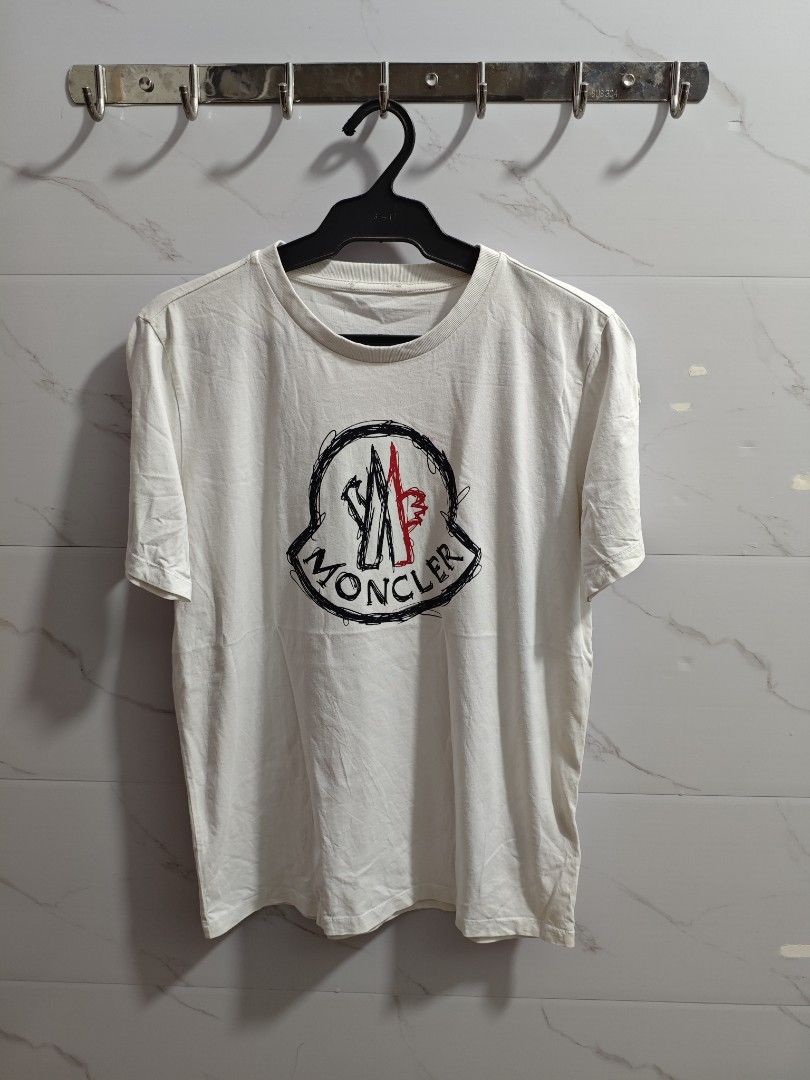 Moncler White Classic Unisex Tshirt (Category: Luxury Apparel) located in Baguio. Submitted by cool_chic (Listing ID 1451602235, Image 1). Description: Moncler Classic Unisex Tshirt Color Rate 9.5/10 Like New Flaw Minimal Stains With Washtag Cotton Tela Machine Washed Size Medium Dimes 19 Width 25 Length Price P499.