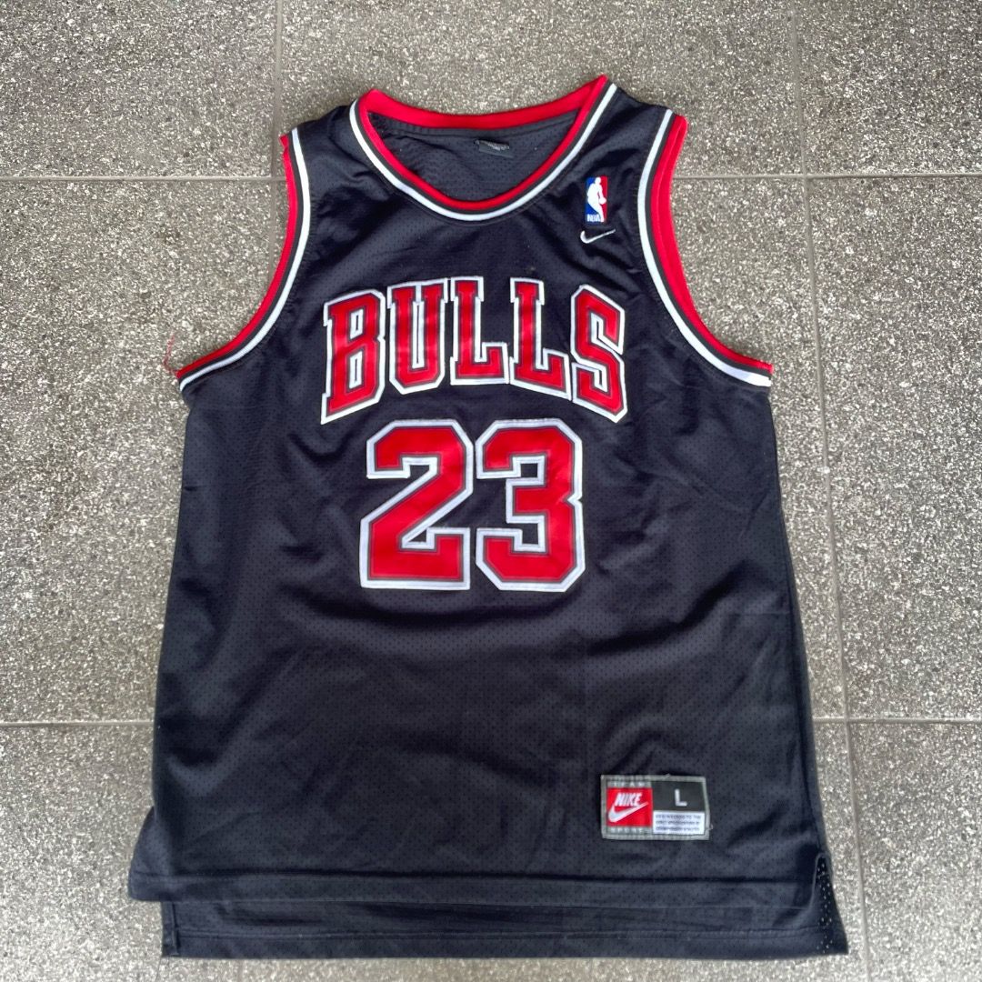 Nike Michael Jordan Chicago Bulls Jersey (Category: Activewear) located in Baguio. Submitted by randomly2600 (Listing ID 1451683288, Image 1). Description: - Classic black Chicago Bulls jersey - Features Michael Jordan's name and number 23 - Made by Nike - Size: Large (L) - Ideal for basketball fans and Bulls supporters.