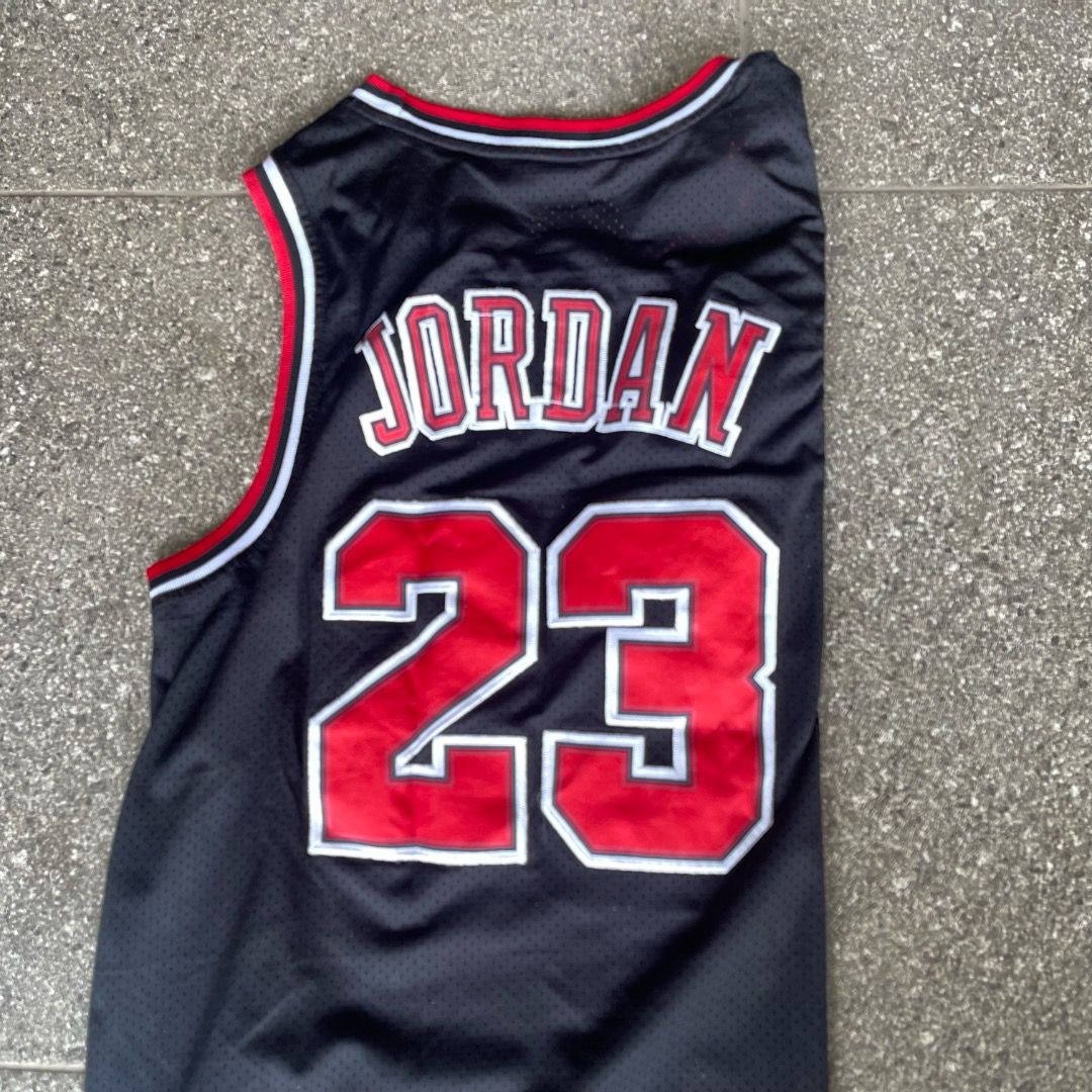 Nike Michael Jordan Chicago Bulls Jersey (Category: Activewear) located in Baguio. Submitted by randomly2600 (Listing ID 1451683288, Image 2). Description: - Classic black Chicago Bulls jersey - Features Michael Jordan's name and number 23 - Made by Nike - Size: Large (L) - Ideal for basketball fans and Bulls supporters.