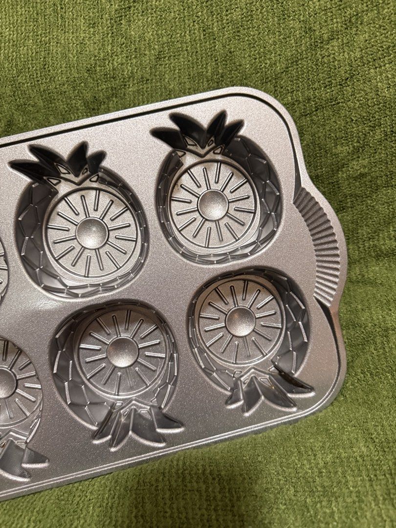 Nordic Ware Pineapple Upside Down Mini Cake Pan (Category: Bakeware) located in Manila. Submitted by georgethjafine (Listing ID 1451687074, Image 2). Description: - Brand: Nordic Ware - Design: Pineapple Upside Down Mini Cake Pan - Makes 6 individual pineapple-shaped cakes - Durable construction for even baking - Perfect for desserts and parties.