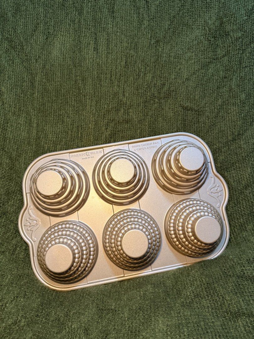 Nordic Ware Tiered Cakelet Pan 6 Cups (Category: Bakeware) located in Manila. Submitted by georgethjafine (Listing ID 1451687285, Image 1). Description: TWO PIECES FOR 2,400 1,300 for ONLY 1 PIECE (You get to save 200 pesos if you get BOTH) - Nordic Ware tiered cakelet pan - Makes 6 cakelets, each holding 1.4 liters - Ideal for mini tiered cakes or cupcakes - Features a non-stick surface - Made in the USA.