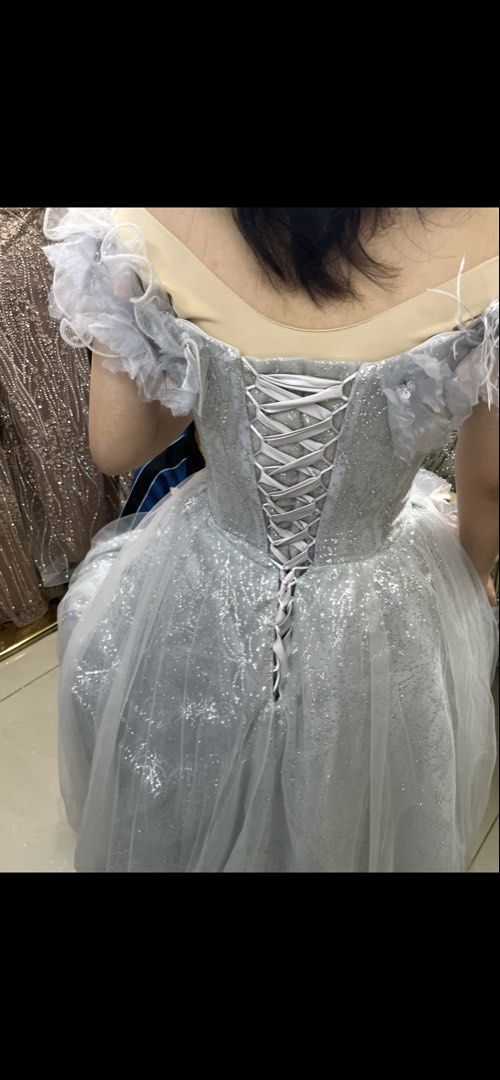Off-shoulder silver Grey Gown with Feathers for debut prom (Category: Evening dresses & gowns) located in Mandaluyong City. Submitted by stephmd (Listing ID 1449536092, Image 3). Description: - Beautiful off-shoulder gown - Delicate feather and butterfly appliques - Sparkly fabric with a flowing tulle skirt - Ideal for formal events or photoshoots Can fit Size small Medium to large Height up to 5’3” Worn only once for the photoshoot Lalamove for 