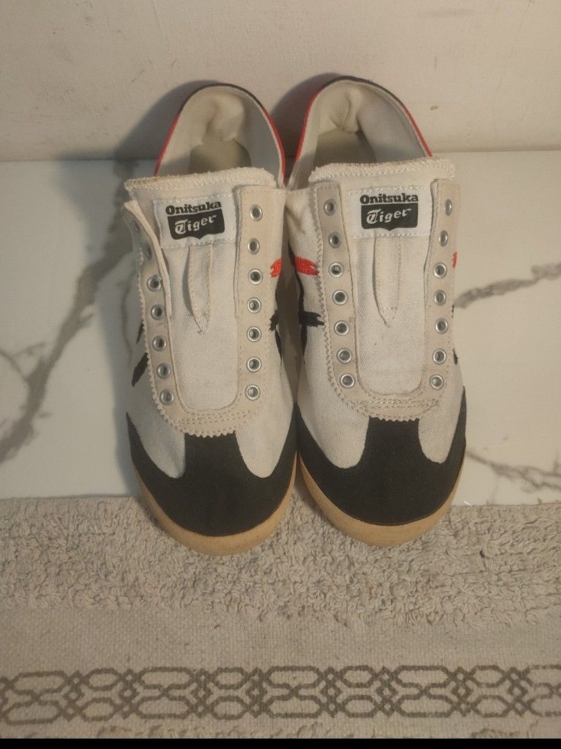 Onitsuka Tiger Mexico 66 Sneakers White Black Red (Category: Sneakers) located in Imus. Submitted by jane369 (Listing ID 1451621982, Image 3). Description: - Classic Onitsuka Tiger Mexico 66 - Color: White with black and red accents - Style: Low-top, perfect for casual wear - Condition: Shows some signs of wear on soles and canvas - Note: Laces are missing - Brand: Onitsuka Tiger (by ASICS) ​ - Line: Mexico 66 Deluxe • NIPPON MADE (premium Japane