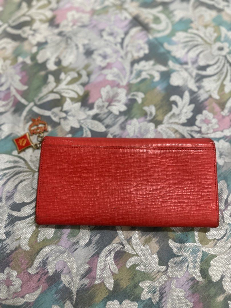 ORIGINAL MCM Red Leather Long Wallet with Charms (Category: Luxury Bags & Wallets) located in Naga. Submitted by bag.net (Listing ID 1451649367, Image 2). Description: - Authentic red MCM long wallet(money back 💯 guaranteed if fake) - Genuine leather with signature MCM logo details - Adorable MCM charms attached - Ample card slots and compartments for organization - Includes a secure zipper pocket -stunning in actual🥰.