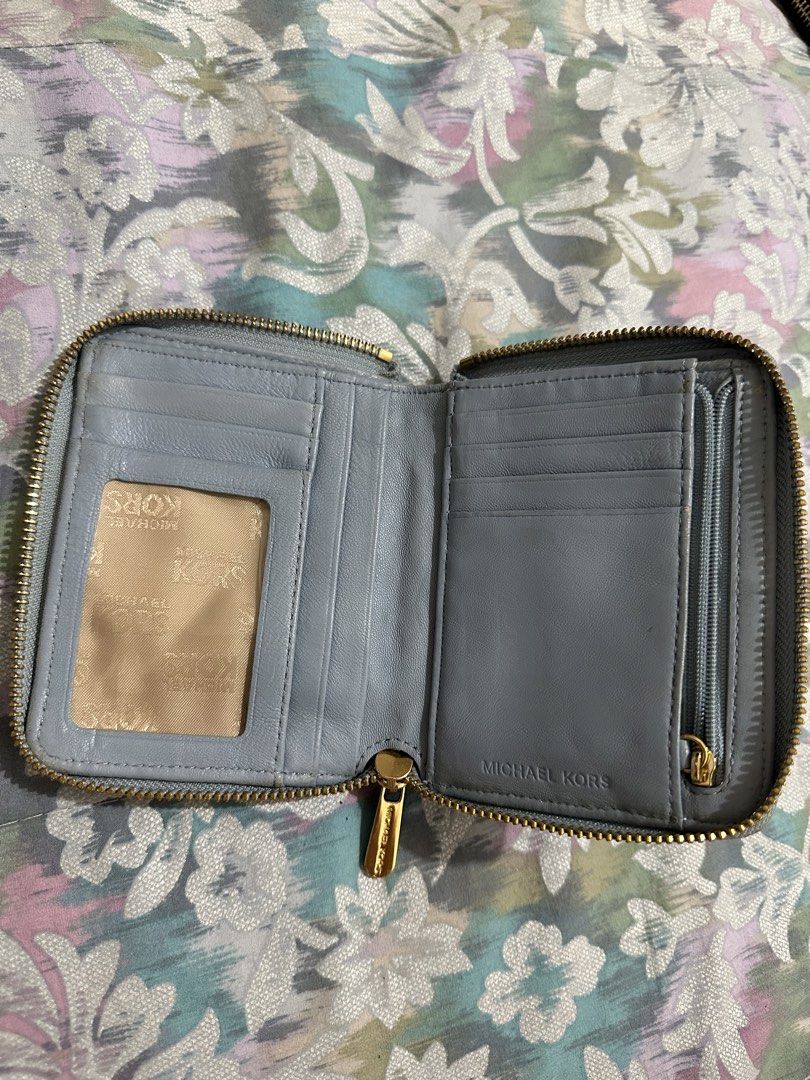 ORIGINAL Michael Kors Quilted Leather Zip Around Wallet (Category: Wallets & Card holders) located in Naga. Submitted by bag.net (Listing ID 1451667346, Image 3). Description: - Light blue Michael Kors wallet - Quilted leather with gold hardware - Zip around closure - Ample card slots and coin pocket - Shows some wear on edges and corners, but plenty of life left.