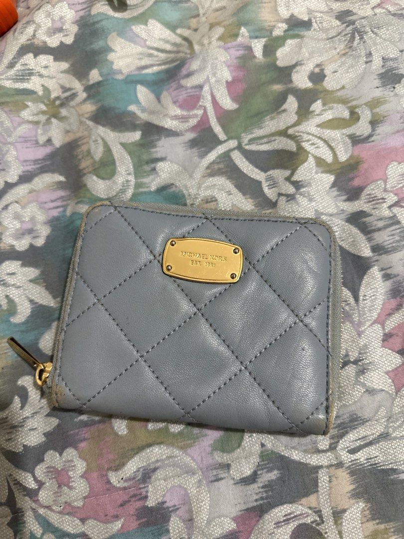 ORIGINAL Michael Kors Quilted Leather Zip Around Wallet (Category: Wallets & Card holders) located in Naga. Submitted by bag.net (Listing ID 1451667346, Image 1). Description: - Light blue Michael Kors wallet - Quilted leather with gold hardware - Zip around closure - Ample card slots and coin pocket - Shows some wear on edges and corners, but plenty of life left.