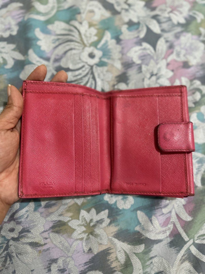 Original Prada Saffiano Leather Wallet Pink (Category: Luxury Bags & Wallets) located in Naga. Submitted by bag.net (Listing ID 1451656792, Image 3). Description: - Authentic Prada wallet(moneyback guaranteed if fake 💯) - Pink Saffiano leather - Bi-fold design with snap closure - Interior: card slots and coin pocket - Signs of wear on exterior and edges - Functional and stylish accessory - Made in Italy.