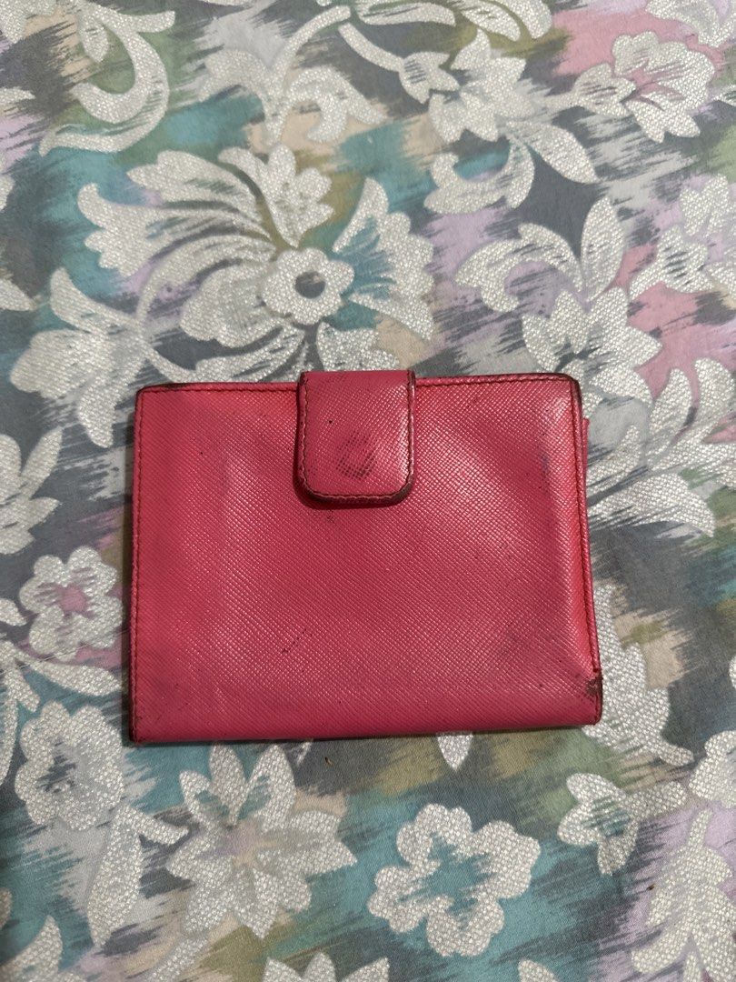 Original Prada Saffiano Leather Wallet Pink (Category: Luxury Bags & Wallets) located in Naga. Submitted by bag.net (Listing ID 1451656792, Image 2). Description: - Authentic Prada wallet(moneyback guaranteed if fake 💯) - Pink Saffiano leather - Bi-fold design with snap closure - Interior: card slots and coin pocket - Signs of wear on exterior and edges - Functional and stylish accessory - Made in Italy.