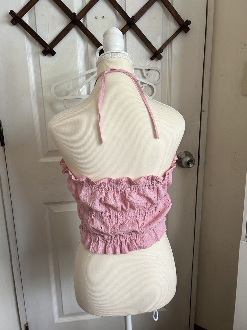 Pink Eyelet Halter Crop Top with Tie Front (Category: Sleeveless) located in Pasig City. Submitted by declutterwithme_agb (Listing ID 1451523777, Image 2). Description: - Adorable pink halter crop top - Made with delicate eyelet fabric - Features charming ruffled edges - Adjustable ties at the front and back of the neck - Smocked back ensures a comfortable and secure fit - Ideal for summer outfits, beach days, or casual wear - Easily pairs with s