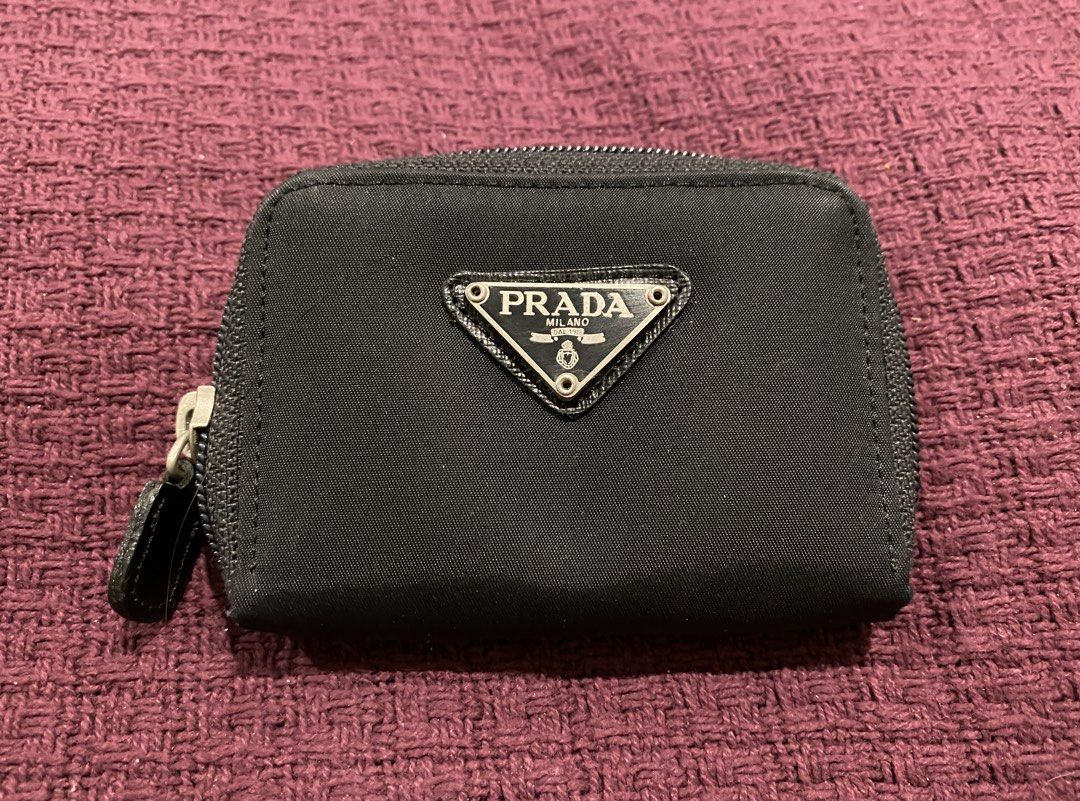 Prada Black Nylon Coin Pouch (Category: Luxury Bags & Wallets) located in Muntinlupa City. Submitted by mj.finds (Listing ID 1451612706, Image 1). Description: - Prada coin pouch - Black nylon material - Zipper closure - Two interior compartments - Small and compact for coins.