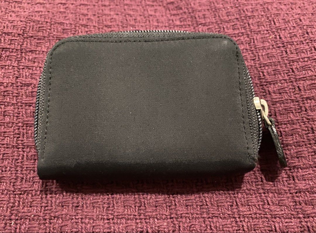 Prada Black Nylon Coin Pouch (Category: Luxury Bags & Wallets) located in Muntinlupa City. Submitted by mj.finds (Listing ID 1451612706, Image 2). Description: - Prada coin pouch - Black nylon material - Zipper closure - Two interior compartments - Small and compact for coins.