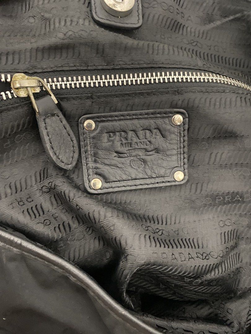 Prada Black Nylon Leather Trim Tote Bag (Category: Luxury Bags & Wallets) located in Paete. Submitted by ladder_leynn (Listing ID 1451646863, Image 3). Description: - Prada Tote Bag - Color: Black - Material: Nylon with Leather Trim and Straps - Hardware: Silver - Interior: Zippered pocket and Prada logo lining - Style: Spacious and practical for everyday use - A timeless Prada classic -AUTH NOT GUARANTEED.