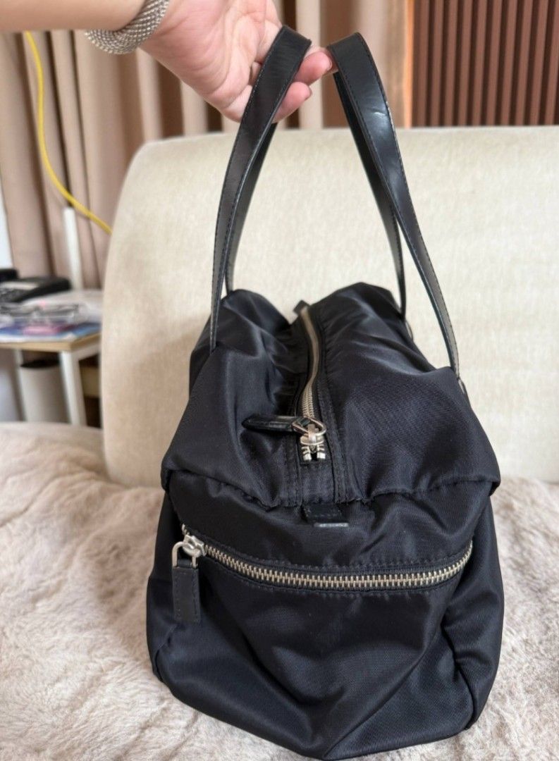 Prada Black Nylon Leather Trimmed Tote Bag (Category: Luxury Bags & Wallets) located in Quezon City. Submitted by deng43763 (Listing ID 1451651103, Image 3). Description: - Classic Prada tote bag - Black nylon with leather handles and trim - Silver hardware details - Zipper closure on top - Front zipper pocket - Spacious interior - Ideal for everyday use or travel.
