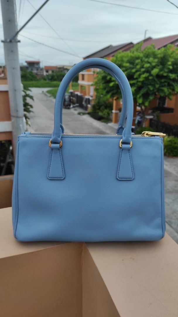 Prada Saffiano Lux Tote Light Blue (Category: Luxury Bags & Wallets) located in Malolos. Submitted by highkeys (Listing ID 1451618458, Image 2). Description: - Authentic Prada Bag - Lovely Light Blue Saffiano Leather - Gold Hardware Details - Top Handles & Zip Closure - Small Leather Tag - No inclusions bag it self only - Versatile for everyday or special occasions.