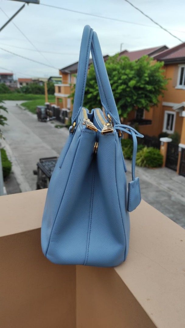 Prada Saffiano Lux Tote Light Blue (Category: Luxury Bags & Wallets) located in Malolos. Submitted by highkeys (Listing ID 1451618458, Image 3). Description: - Authentic Prada Bag - Lovely Light Blue Saffiano Leather - Gold Hardware Details - Top Handles & Zip Closure - Small Leather Tag - No inclusions bag it self only - Versatile for everyday or special occasions.