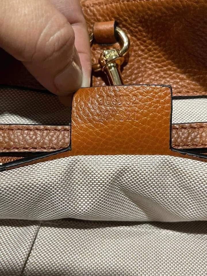 Preloved gutzzzii soho leather chain tote (Category: Luxury Bags & Wallets) located in Los Banos. Submitted by ditasbautista2329 (Listing ID 1451663633, Image 3). Description: Premium pebbled leather • Iconic embossed GG logo • Gold-tone chain shoulder straps • Leather tassel accent • Spacious interior • Color: Cognac/Tan Brown • Elegant at versatile design.