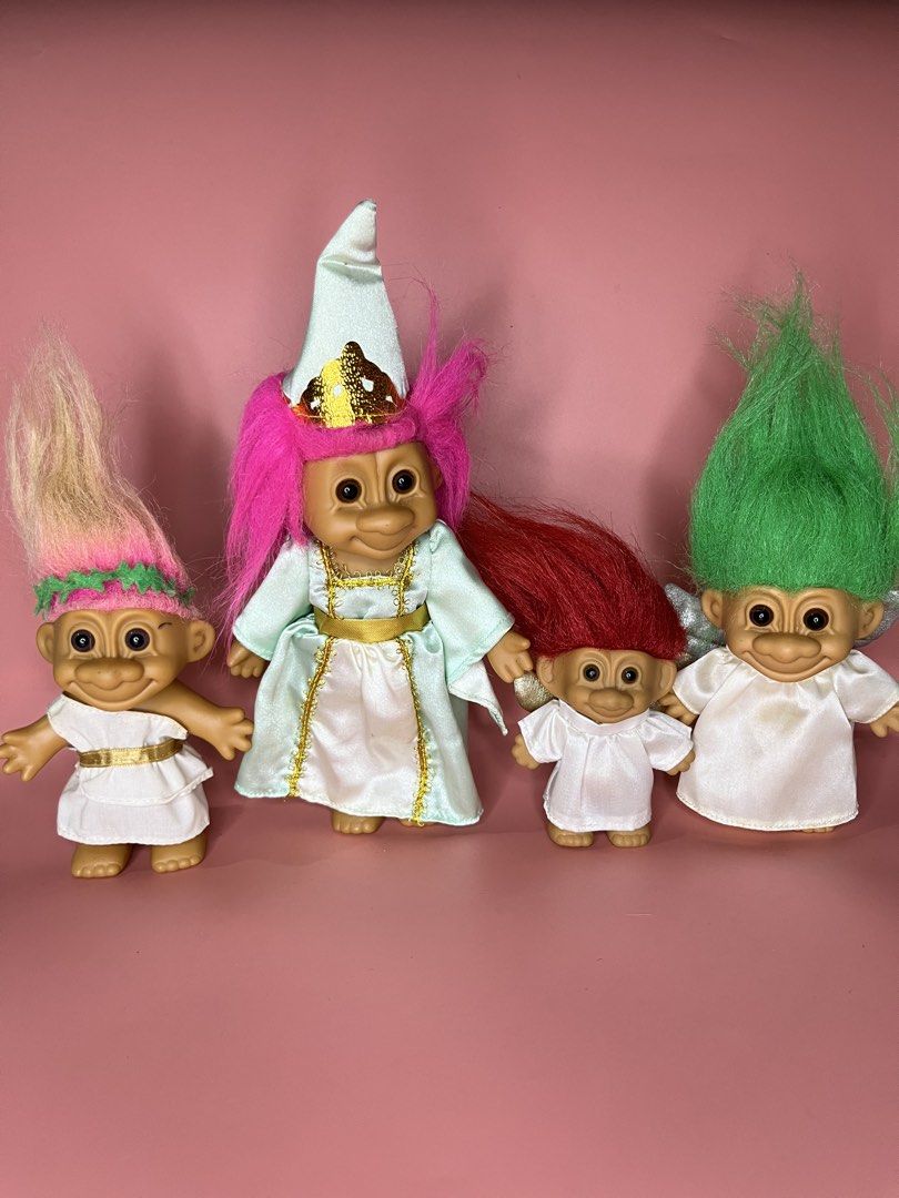 Russ Troll Dolls Set - Princess & Angels (Category: Figurines & Statues) located in Caloocan City. Submitted by snapshop_ph (Listing ID 1451578452, Image 1). Description: - Set of 4 vintage Russ troll dolls, perfect for collectors! - 1 Princess Troll: Dressed in a light blue gown with a crown. - 3 Angel Trolls: Wearing white outfits with wings. - Hair Colors: One pink, one red, and two green. - Authentic Russ branding and 'Made in China' marked o