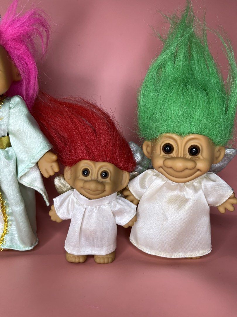 Russ Troll Dolls Set - Princess & Angels (Category: Figurines & Statues) located in Caloocan City. Submitted by snapshop_ph (Listing ID 1451578452, Image 3). Description: - Set of 4 vintage Russ troll dolls, perfect for collectors! - 1 Princess Troll: Dressed in a light blue gown with a crown. - 3 Angel Trolls: Wearing white outfits with wings. - Hair Colors: One pink, one red, and two green. - Authentic Russ branding and 'Made in China' marked o