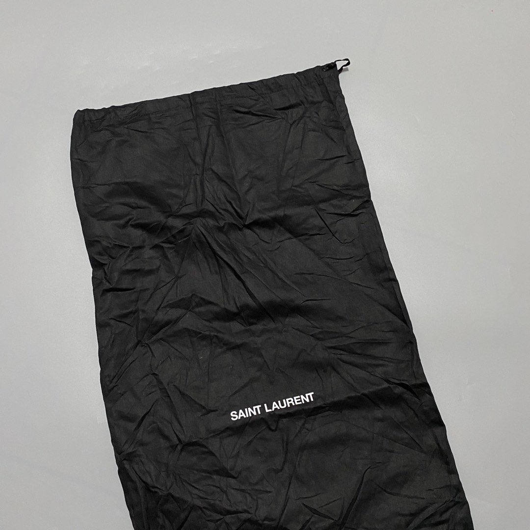 Saint Laurent Black Dust Bag (Category: Luxury Bags & Wallets) located in Imus. Submitted by fndsvntg_307 (Listing ID 1451671562, Image 2). Description: - Authentic Saint Laurent dust bag - Black fabric with white logo - Secure drawstring closure - Ideal for protecting designer bags or shoes - Keeps items safe and dust-free - Approximate dimensions: X by Y inches.