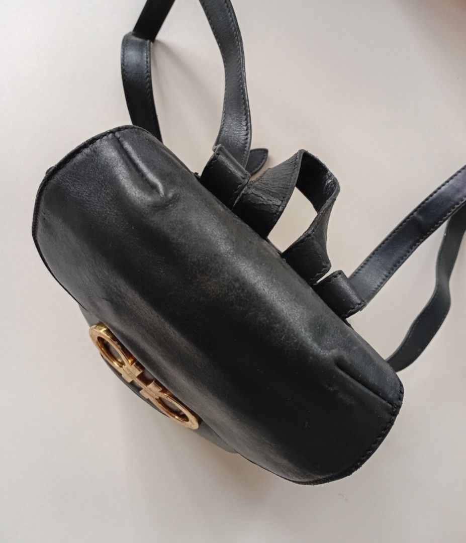 Salvatore Ferragamo Gancini leather Backpack (Category: Luxury Bags & Wallets) located in Navotas City. Submitted by ms.soulana (Listing ID 1451645069, Image 3). Description: PreOwned lightly Used WellUsed Authentic Salvatore Ferragamo Gancini black leather Compact Sized backpack - Iconic gold-tone Gancini hardware - Secure drawstring closure with a flap top - Adjustable leather shoulder straps - Perfect for everyday use Please note: some signs o