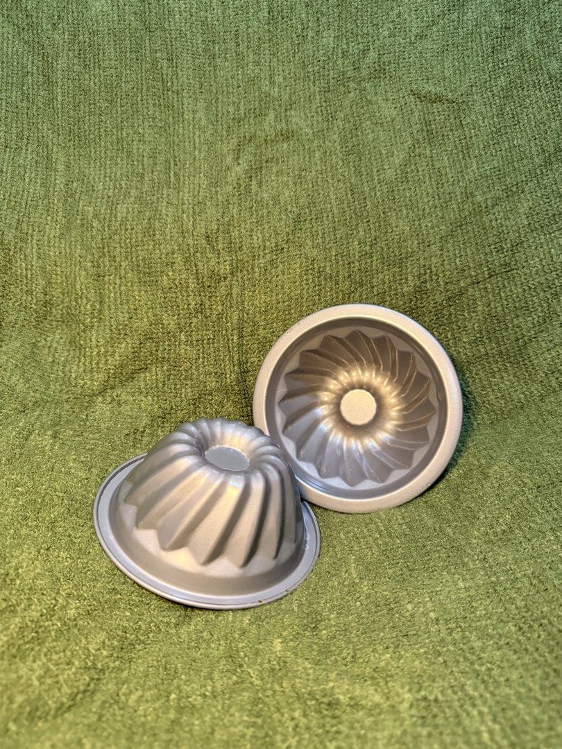 Set of 2 Mini Bundt Cake Molds (Category: Bakeware) located in Manila. Submitted by georgethjafine (Listing ID 1451687896, Image 1). Description: - Set of 2 mini bundt cake molds - Features a classic fluted design - Ideal for individual desserts or small cakes - Made of durable metal - Ready for your next baking adventure!.