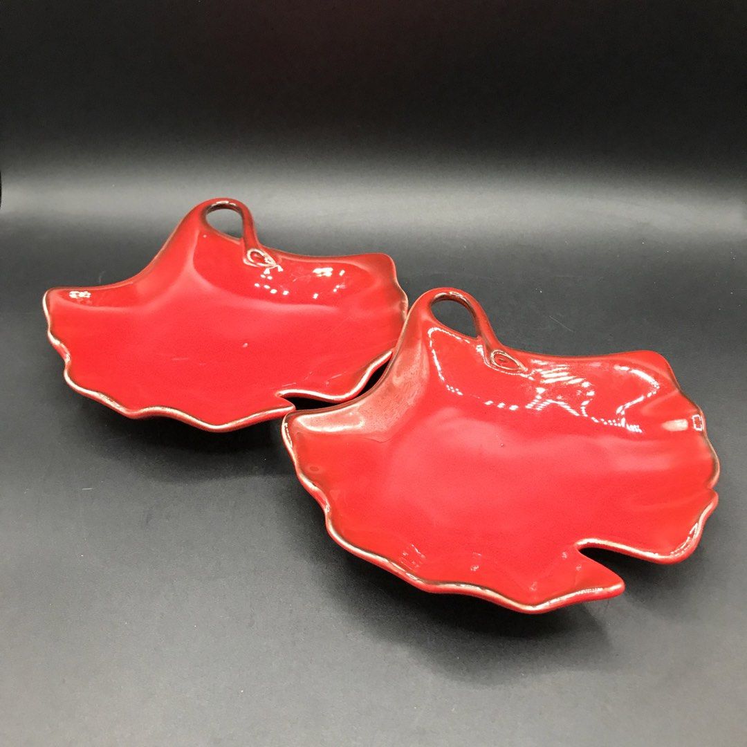 Set of 2 Red Leaf Shaped Serving Dishes with Handles (Category: Dinnerware & Cutlery) located in Baao. Submitted by all.things.japan (Listing ID 1451548992, Image 2). Description: - 6.0 x 6.0 inches -Set of two (2) red leaf-shaped dishes. - Each dish features a small handle. - Subtle silver trim along the edges. - Perfect for serving snacks or small appetizers. - Adds a festive touch to any table setting. - Designed to stack neatly for convenient