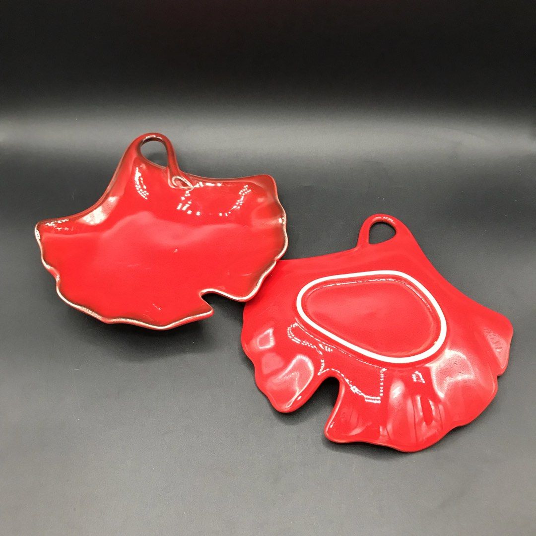 Set of 2 Red Leaf Shaped Serving Dishes with Handles (Category: Dinnerware & Cutlery) located in Baao. Submitted by all.things.japan (Listing ID 1451548992, Image 3). Description: - 6.0 x 6.0 inches -Set of two (2) red leaf-shaped dishes. - Each dish features a small handle. - Subtle silver trim along the edges. - Perfect for serving snacks or small appetizers. - Adds a festive touch to any table setting. - Designed to stack neatly for convenient