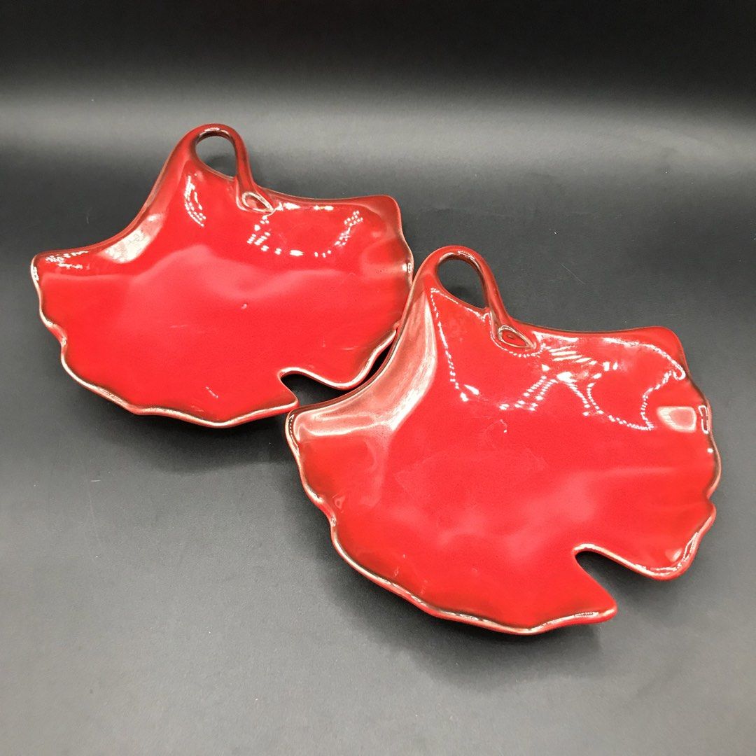 Set of 2 Red Leaf Shaped Serving Dishes with Handles (Category: Dinnerware & Cutlery) located in Baao. Submitted by all.things.japan (Listing ID 1451548992, Image 1). Description: - 6.0 x 6.0 inches -Set of two (2) red leaf-shaped dishes. - Each dish features a small handle. - Subtle silver trim along the edges. - Perfect for serving snacks or small appetizers. - Adds a festive touch to any table setting. - Designed to stack neatly for convenient