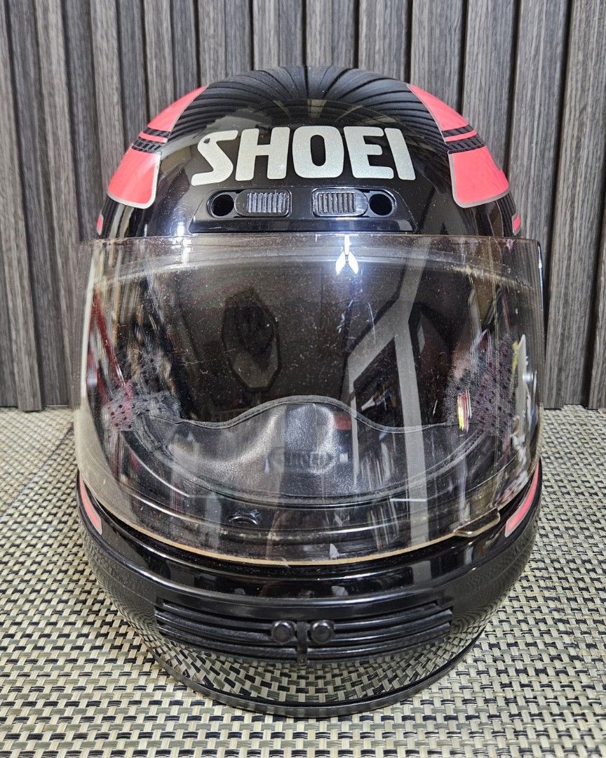 Shoei Motorcycle Helmet - Black Pink Silver (Category: Helmets and other Riding Gears) located in Rizal. Submitted by cherry_garcia (Listing ID 1451583326, Image 2). Description: - Shoei full-face motorcycle helmet / Authentic - Color: Black with pink and silver racing stripes - Visor: Clear - Condition: Visible scuffs and scratches on exterior (especially top), interior is clean - Ready for your next ride.