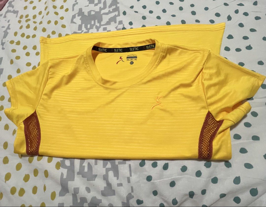 SLETIC Yellow Athletic T-shirt Size M (Category: Tshirts & Polo Shirts ) located in Antipolo. Submitted by murapod2 (Listing ID 1451529856, Image 3). Description: - Brand: SLETIC - Color: Yellow - Size: M - Design: Striped pattern on front and back - Features: Breathable mesh side panels - Sleeves: Short sleeves - Neckline: Crew neck - Ideal for: Workouts, athletic activities, casual wear.