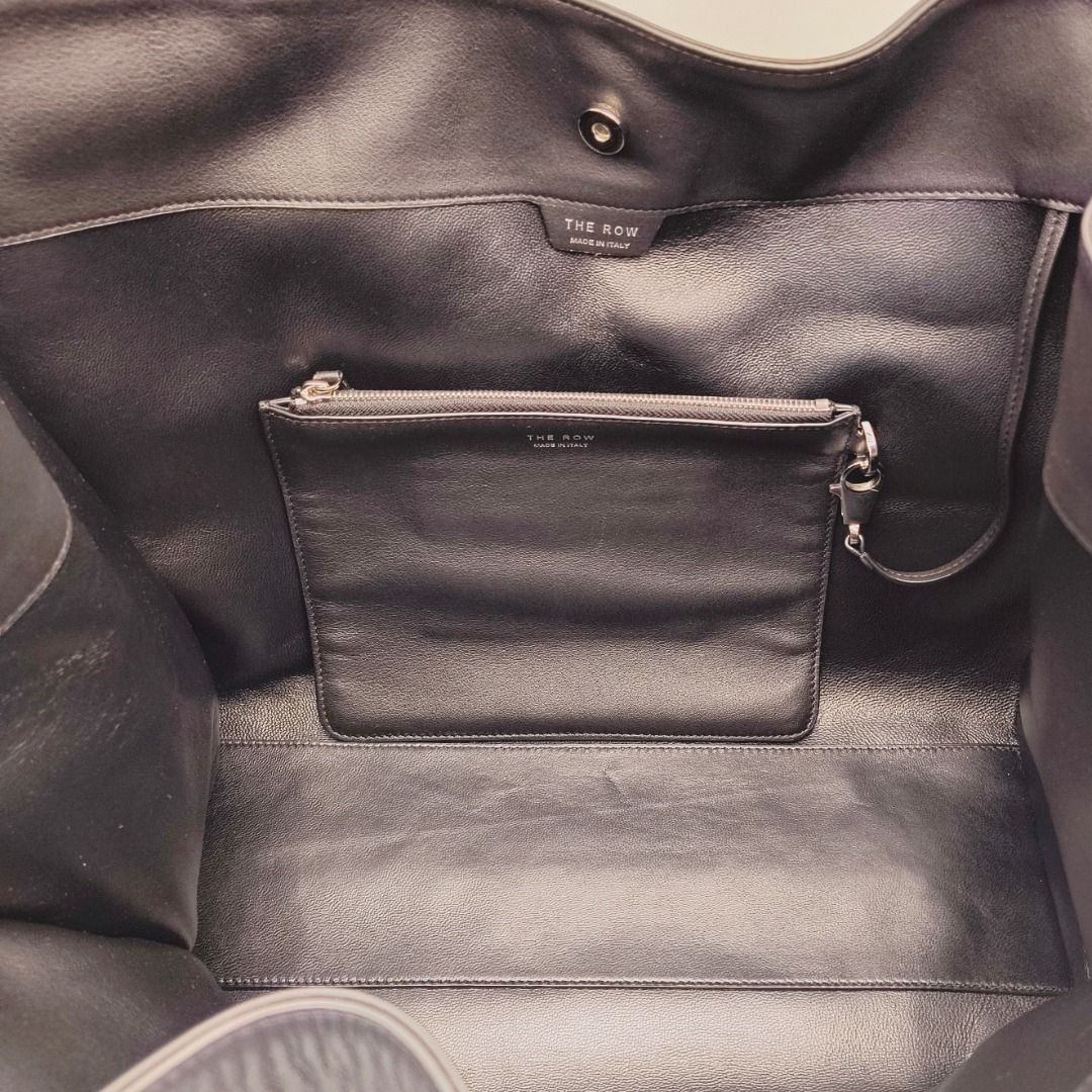 The Row Alexia Tote Bag Black (Category: Luxury Bags & Wallets) located in Cebu City. Submitted by theluxxaffair (Listing ID 1451605352, Image 3). Description: Authentic The Row Alexia tote bag in black calfskin leather. A minimalist structured silhouette with soft curves and polished silver-tone hardware, finished with an understated yet quietly luxurious feel. Features a spacious interior with a detachable leather zip pouch included. Elegant an