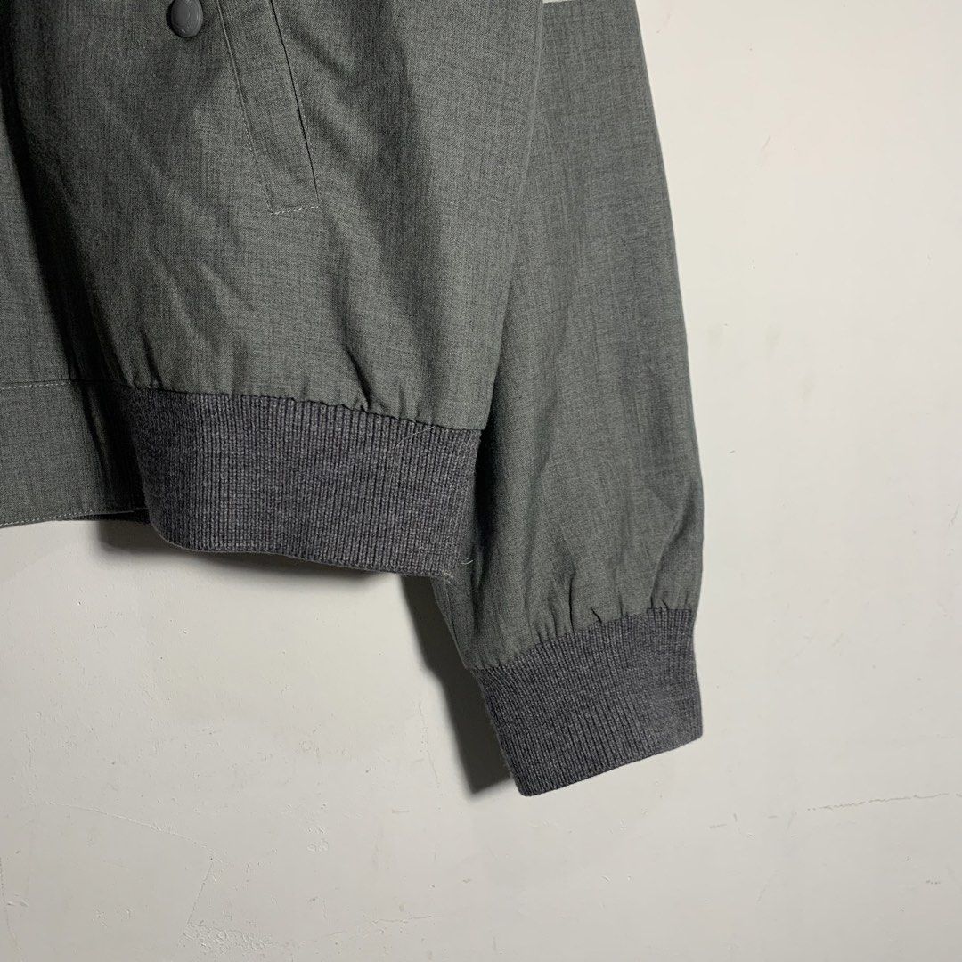 Thom Browne Grey Bomber Jacket Made in Japan (Category: Coats, Jackets and Outerwear) located in Manila. Submitted by gentleflower-74686a (Listing ID 1451672639, Image 3). Description: - Authentic Thom Browne grey bomber jacket - Made in Japan - Signature four-stripe detail on sleeve - Striped lining - Zipper closure - Button pockets - Ribbed collar, cuffs, and hem - Versatile and stylish wardrobe essential.