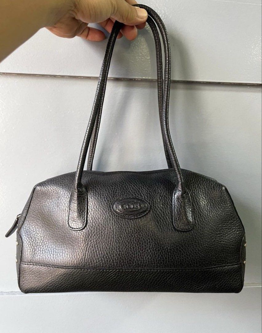 Authentic TOD'S Black Leather Studded Shoulder Bag (Category: Luxury Bags & Wallets) located in Quezon City. Submitted by ashi_shop (Listing ID 1451631832, Image 2). Description: - Authentic TOD’S black leather shoulder bag - Features pebbled leather texture - Stylish silver stud details on sides - Secure zipper closure - Comfortable shoulder straps for easy carrying - Ideal for everyday use -Very classy design -In very good condition, with minim