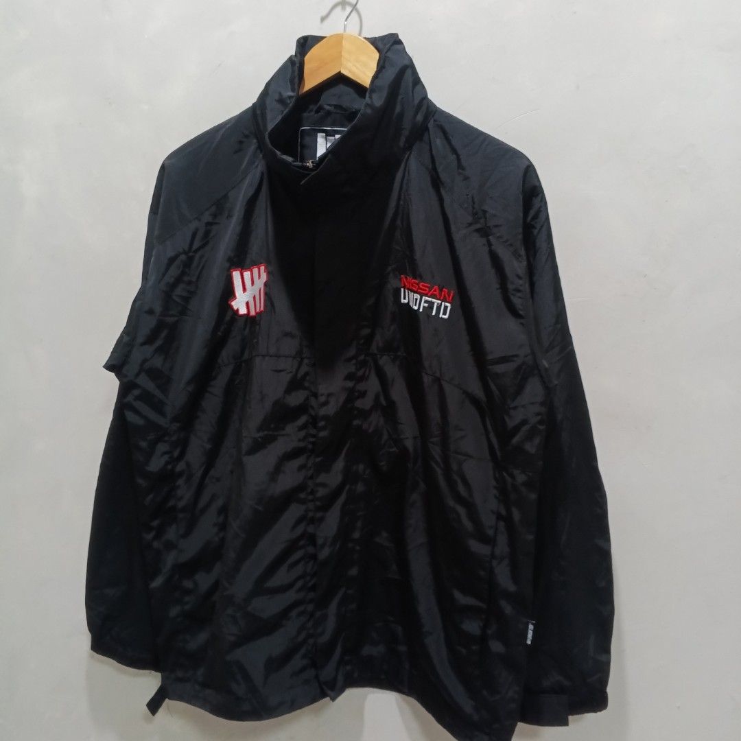 Undefeated x Nissan Packable Hood (Category: Coats, Jackets and Outerwear) located in Malasiqui. Submitted by drie_findss (Listing ID 1451599136, Image 2). Description: Undefeated x Nissan Packable Hood (Authentic) ‎_______________________ ‎Size: L on tag ‎(Measured by Inches) ‎Width: 23 ‎Length: 27 ‎Shoulder: 20 ‎Sleeve: 23 ‎Condition: EXCELLENT ‎Color Rate: 10/10 ‎Issue: None ‎_______________________ ‎ ‎Color may vary due to lightning so check 