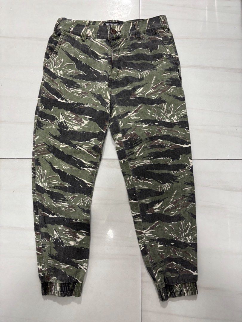 Untouched Tiger Camo Jogger Pants Size M (Category: Joggers) located in Quezon City. Submitted by edether (Listing ID 1451630359, Image 1). Description: - Brand: Untouched - Style: Tiger Camo Joggers - Size: Medium (M) - Features: Elasticated cuffs - Ideal for: Casual wear - Unique design: Stand out with the tiger camouflage pattern UNISEX Waist - 30in Length- 36in If you see it posted, it’s available. Last price and details are posted. No reply 
