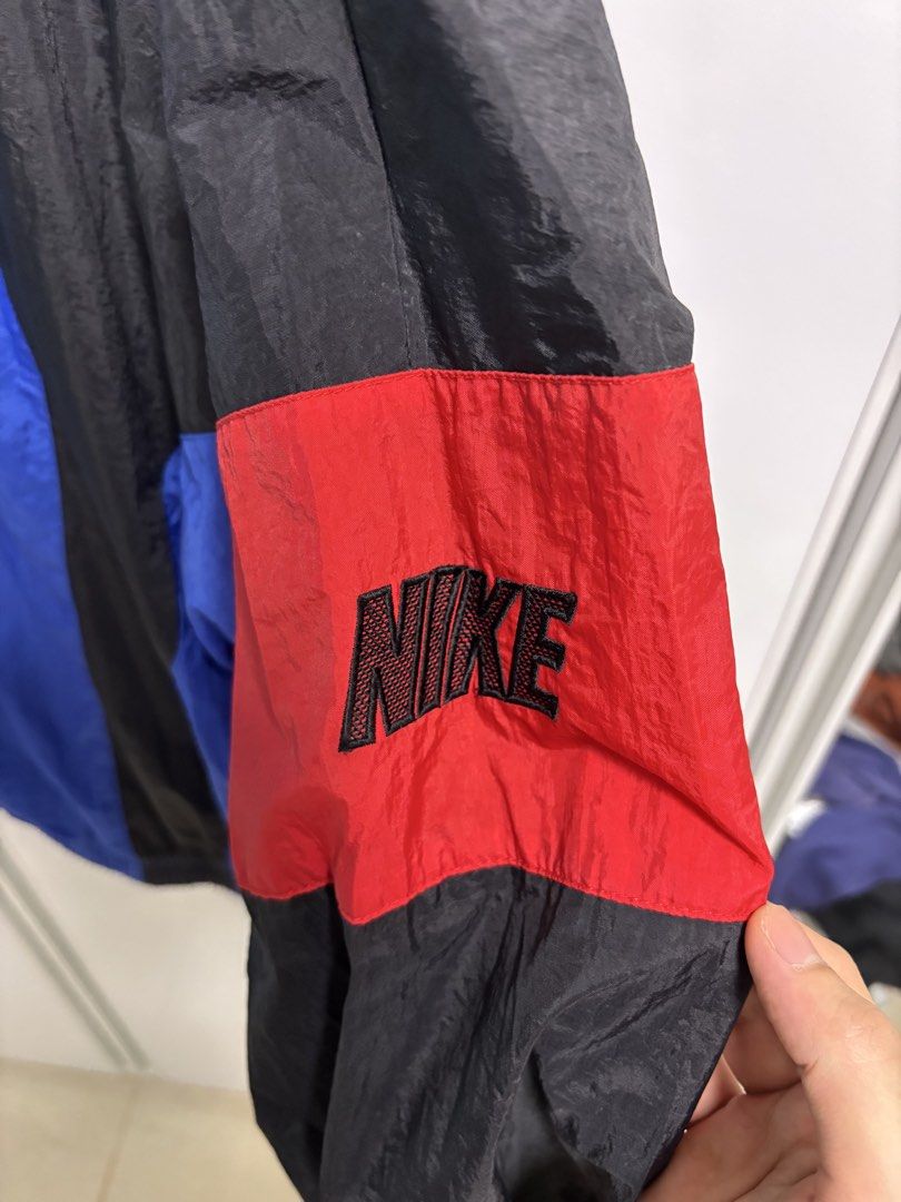 Vintage Nike Windbreaker Jacket Blue Black Red (Category: Coats, Jackets and Outerwear) located in San Fernando. Submitted by blique2018 (Listing ID 1451654673, Image 3). Description: - Classic Nike windbreaker - Bold blue, black, and red color block design - Lightweight material, perfect for layering - Iconic Nike swoosh on chest and logo on sleeve - Full zip closure - Elastic cuffs and hem - Size: XL - Dimes: 27.5 x 27.5 - Condition: 8/10; ink 