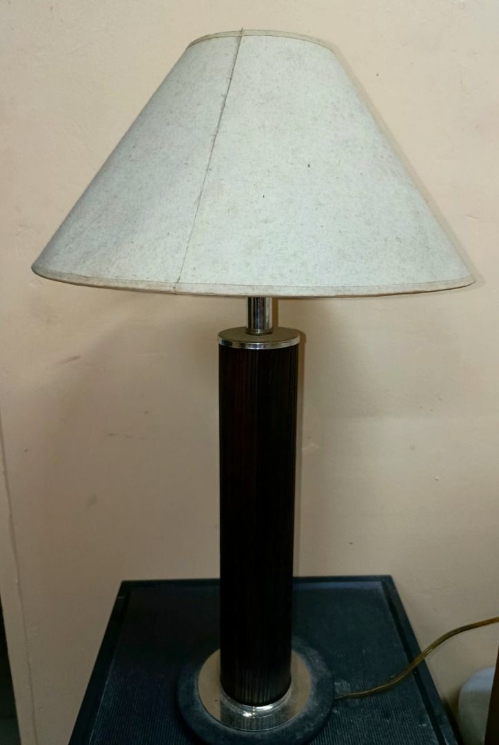 Vintage Table Lamp Shade White (Category: Lighting) located in Manila. Submitted by metrolistings (Listing ID 1451612539, Image 2). Description: - Classic table lamp design - Dark, ribbed cylindrical base with metallic trim - Light-colored conical shade - Provides a warm glow - Ideal for bedside tables or desks.