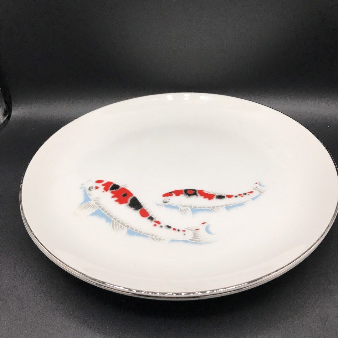 White Plate with Koi Fish Design and Silver Rim (Category: Dinnerware & Cutlery) located in Baao. Submitted by all.things.japan (Listing ID 1451561103, Image 2). Description: - 9.10 inches diameter - Beautiful white ceramic plate, 10 inches in diameter. - Features two striking koi fish in red, black, white, and blue. - Elegant silver band around the rim. - Ideal for both decorative display and serving food. - Adds a touch of sophistication to any