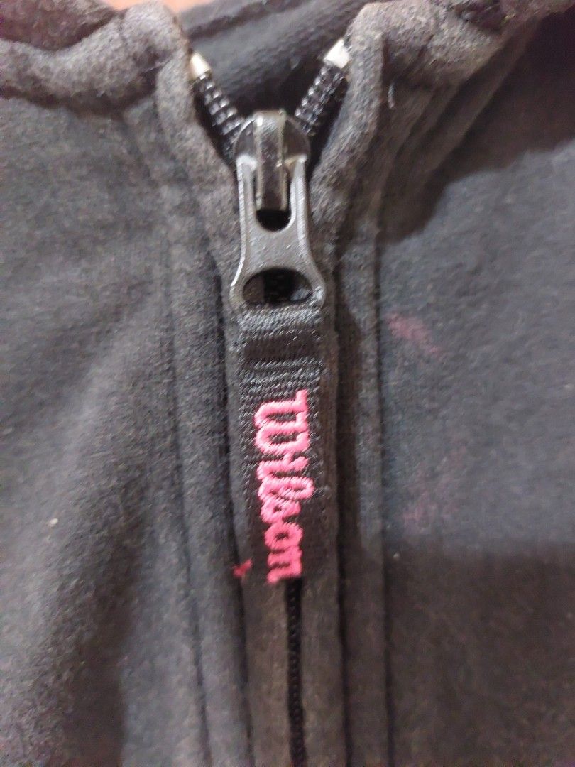 Wilson Black Zip-Up Hoodie (Category: Coats, Jackets and Outerwear) located in Malaybalay. Submitted by mags_sofia (Listing ID 1451608190, Image 3). Description: - Black Wilson full-zip hoodie - Red accents on zippers - Embroidered Wilson logo on chest - Embroidered logo on zipper pull - Front pockets - Some faint marks on the front (please check photos) - Comfortable and casual wear.