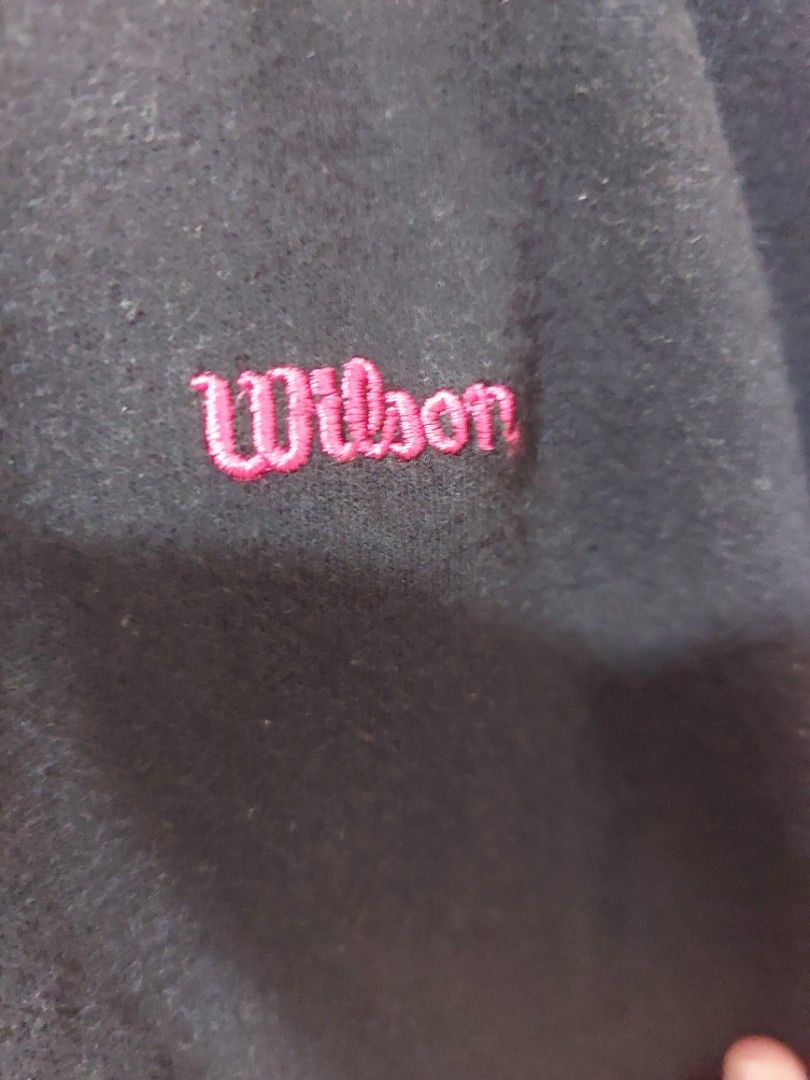 Wilson Black Zip-Up Hoodie (Category: Coats, Jackets and Outerwear) located in Malaybalay. Submitted by mags_sofia (Listing ID 1451608190, Image 2). Description: - Black Wilson full-zip hoodie - Red accents on zippers - Embroidered Wilson logo on chest - Embroidered logo on zipper pull - Front pockets - Some faint marks on the front (please check photos) - Comfortable and casual wear.