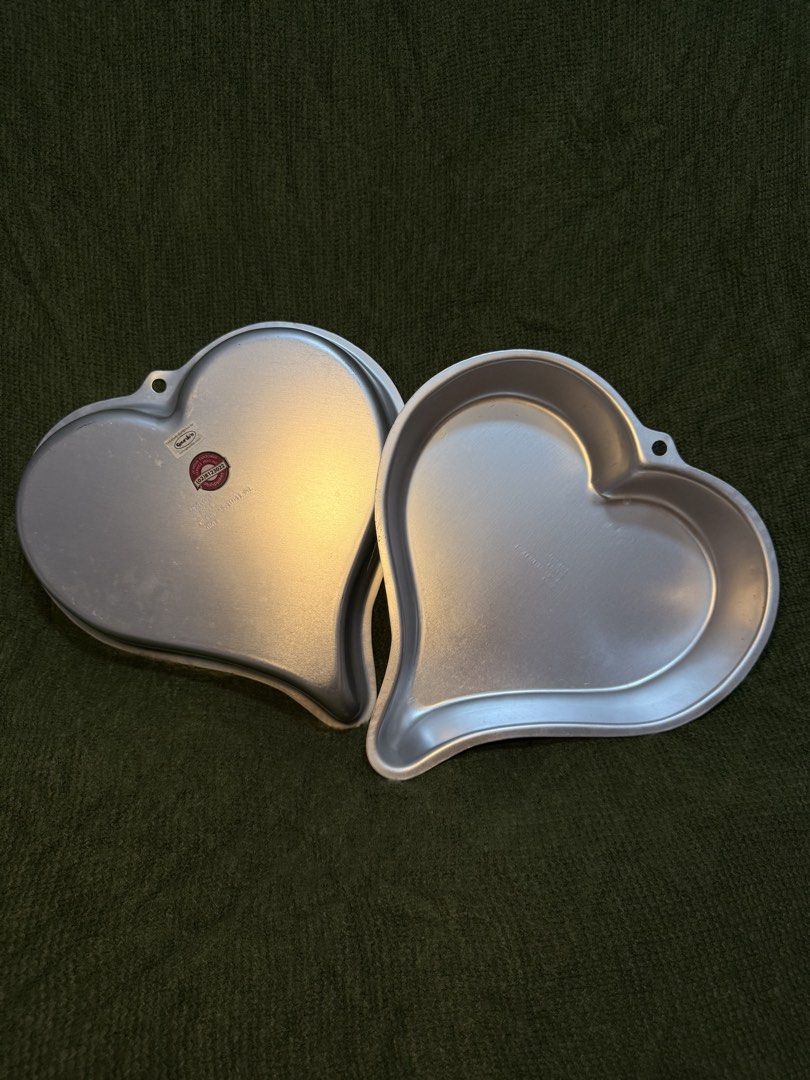 Wilton Heart Shaped Cake Pan Set (Category: Bakeware) located in Manila. Submitted by georgethjafine (Listing ID 1451688083, Image 1). Description: - Set of two Wilton heart-shaped cake pans. - One pan features a 'Gundos' sticker. - Ideal for Valentine's Day, anniversaries, or any special occasion. - Simple to use and clean for hassle-free baking. - Unleash your creativity with unique cake designs..