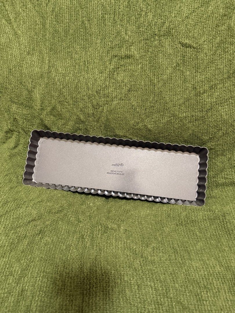 Wilton Rectangular Tart Pan with Removable Bottom (Category: Cookware & Accessories) located in Manila. Submitted by georgethjafine (Listing ID 1451689125, Image 2). Description: - Rectangular tart pan - Fluted edge design - Dimensions: 10 x 3.5 inches - Non-stick surface for easy release - Ideal for baking quiches and tarts - Simple to use and clean.