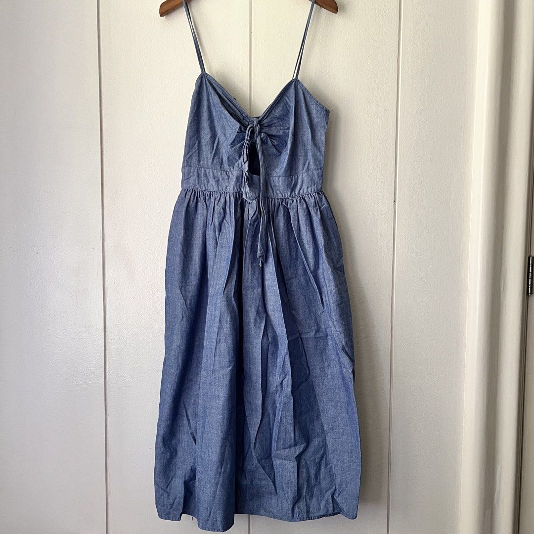 Zara Denim Blue Dress (Category: Dresses) located in Quezon City. Submitted by nchm88 (Listing ID 1451543508, Image 3). Description: Really pretty Zara denim dress - zipper closure at the back - thin adjustable shoulder straps - ribbon tie detail in front - soft denim fabric - below the knee length - used a few times, less than 5 times only, still good as new, no issues or damages - size xs/s - no when worn photo since this does not fit me anymor