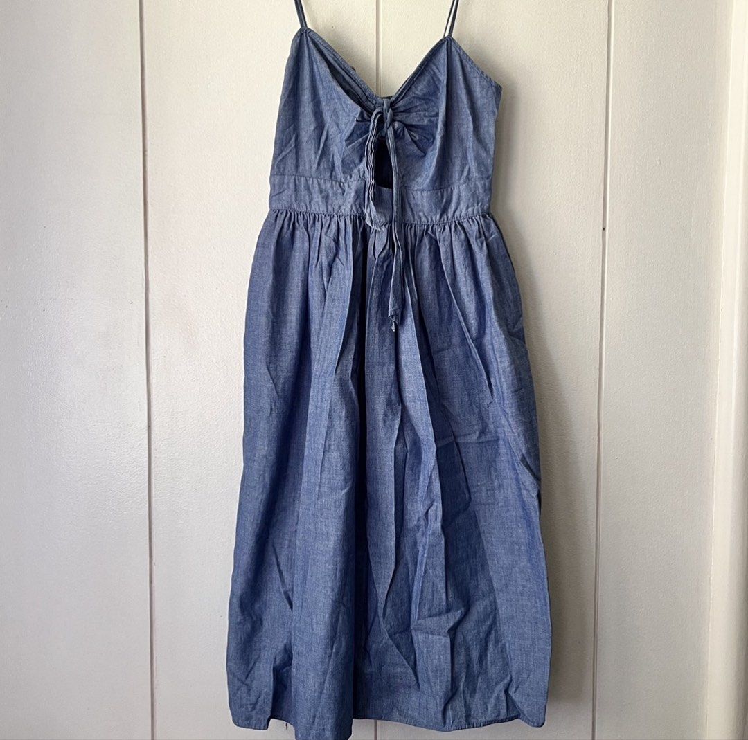 Zara Denim Blue Dress (Category: Dresses) located in Quezon City. Submitted by nchm88 (Listing ID 1451543508, Image 2). Description: Really pretty Zara denim dress - zipper closure at the back - thin adjustable shoulder straps - ribbon tie detail in front - soft denim fabric - below the knee length - used a few times, less than 5 times only, still good as new, no issues or damages - size xs/s - no when worn photo since this does not fit me anymor