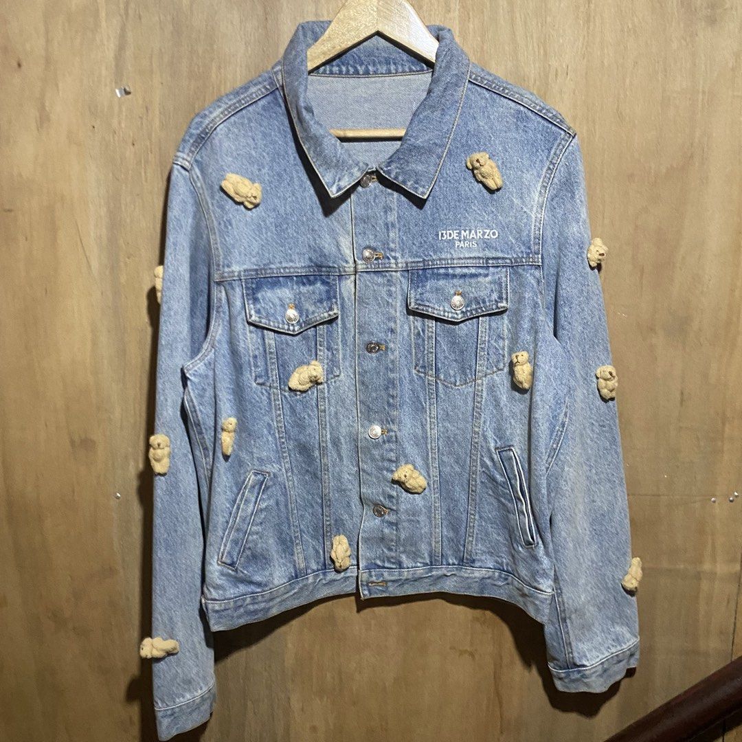 13DE MARZO PARIS Denim Jacket with Teddy Bear Embellishments (Category: Coats, Jackets and Outerwear) located in Manila. Submitted by drp4drp (Listing ID 1451840231, Image 1). Description: Dimes: Length 25 Width 21.5 shoulder to wrist 27 wrist hem 6 In very good condition Just need wash - 13DE MARZO PARIS denim jacket - Features a fun, all-over teddy bear print - Classic button-up front closure - Two chest pockets for convenience - A unique and e